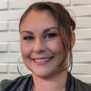 Smiling woman with dark hair in an updo